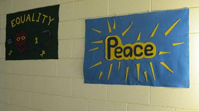 felt signs saying "Equality" and "Peace"